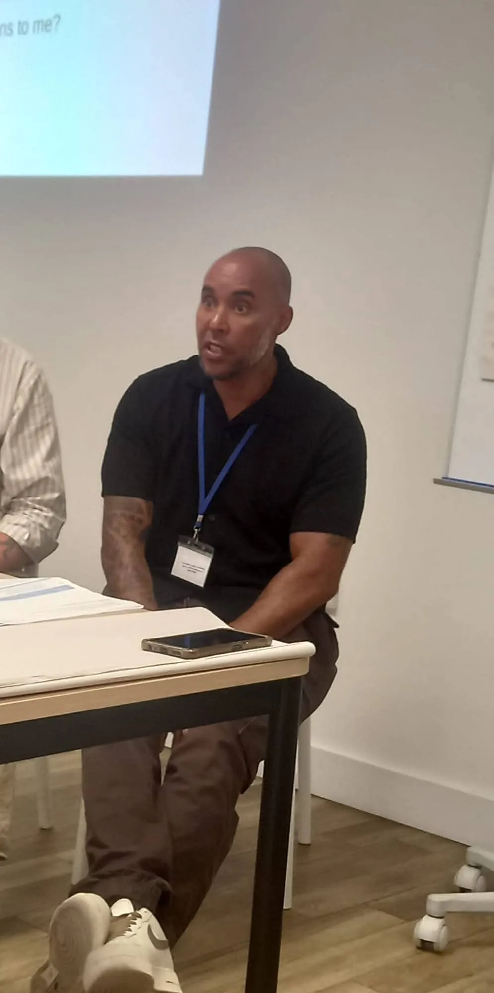 Taff Jones speaking during a workshop with staff seated nearby
